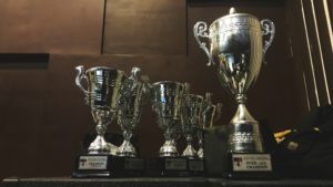 three gold trophies in case